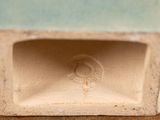 a close up of a vase on a wooden table