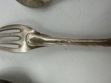 two spoons and a fork on a table