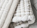 a close up of a blanket on a white wooden floor