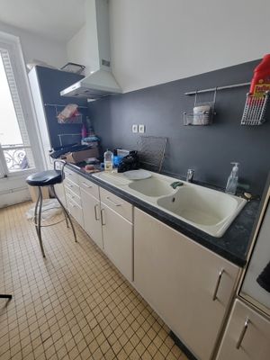 a kitchen with a sink, stove, and refrigerator in it