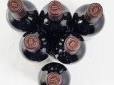 six bottles of wine sitting on top of each other