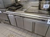 stainless steel counter top with pots and pans on it in a commercial kitchen