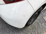a white car parked on the side of the street