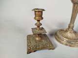pair of antique brass candlesticks on stand on white background