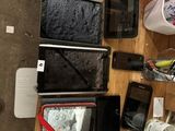 a table with a lot of cell phones and a purse on it
