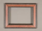 a close up of a picture frame hanging on a wall