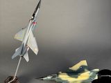 a small model of a fighter jet next to a small model of a fighter jet