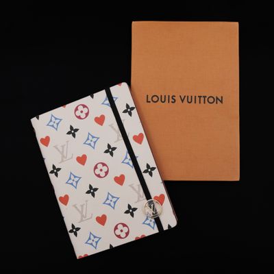 a louis vuitton notebook with a heart and star pattern on it