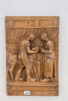 relief en bois représentant un homme et une femme dans une cuisine