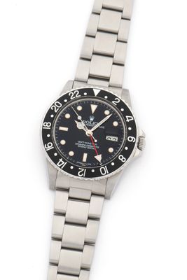 a close up of a wrist watch on a white surface