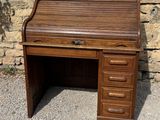 a small wooden cabinet on the side of a stone wall