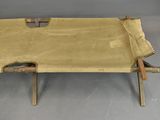 a bench made out of a sheet of paper on a gray floor