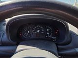 dashboard view of a car with a steering wheel and a speedometer