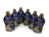 quatre bouteilles de lait à la vanille Veet sur fond blanc