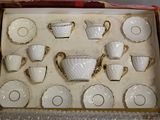a box with a set of cups and saucers in it