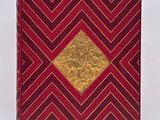 a red and gold book with a gold diamond on the cover