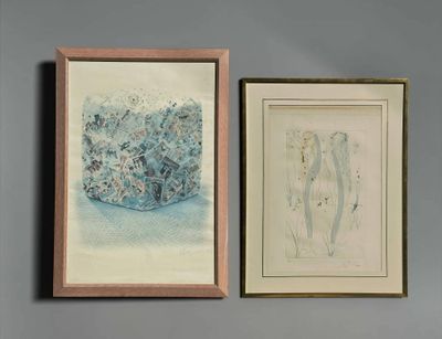 two framed paintings on a wall above a bed with a blue comforter