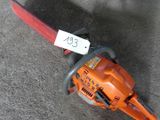 a chainsaw on the ground with a price tag on it
