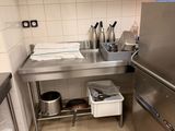 a kitchen with a stainless steel sink and a refrigerator
