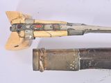 two different types of weapons displayed on a white surface