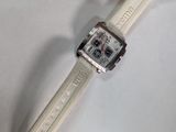 a watch that is laying on a white surface