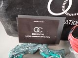 a black bag with a red ribbon and a pair of scissors on it