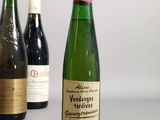 several bottles of wine are lined up on a table