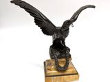 statue of an eagle on a marble base on a white background