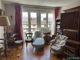a living room with a couch, chairs, and a piano in it