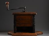 an old coffee grinder with a wooden base and a wooden handle