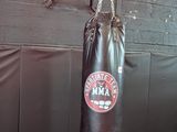 a man standing in a boxing ring with a punching bag