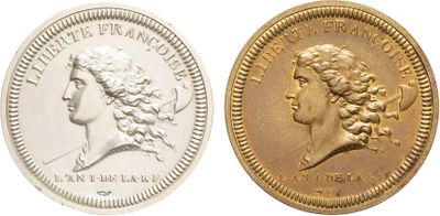 a close up of two gold coins on a white background