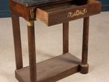 a small wooden table with a drawer on top of it