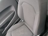 the interior of a car with two seats and a cup holder in the center