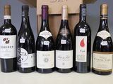 several bottles of wine are lined up in a row on a table
