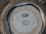 a close up of a vase with a number on it