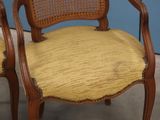 pair of antique cane back chairs with yellow upholstered cushions