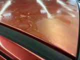 a close up of a car ' s hood with a lot of water on it