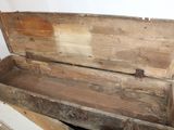 a wooden box that is sitting in the corner of a room
