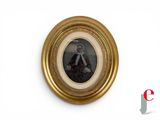 a picture of a woman in a gold frame on the wall