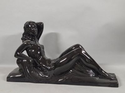 statue of a woman reclining on a chair on a white background