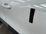 a sticker on the side of a white car