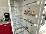 an open refrigerator in a kitchen with a lot of food on the shelves
