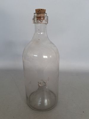 a small glass bottle with a cork stopper on it