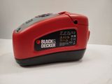 the black decker battery charger is sitting on a white surface