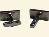 pair of black and silver cufflinks on a white background