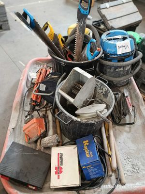 a tray of tools and tools sitting on the floor