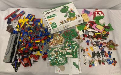 un tas de Lego sur un lit, avec une boîte de Lego
