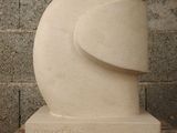 a white sculpture of an elephant head on a table