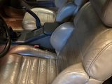the interior of a car with leather seats and a steering wheel